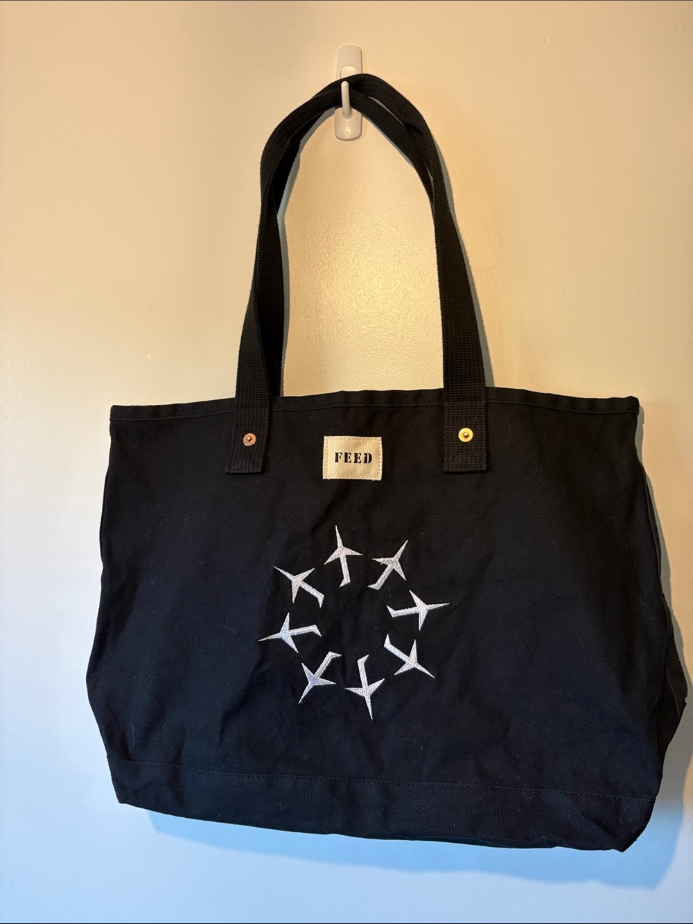 FEED Black Canvas Tote with Airplane Circle Graphic